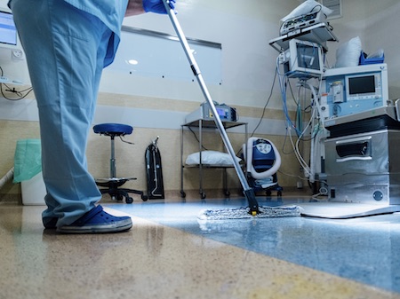 Concept Photo Of A Hospital Worker Doing Cleaning In Operation Room. Medical waste management